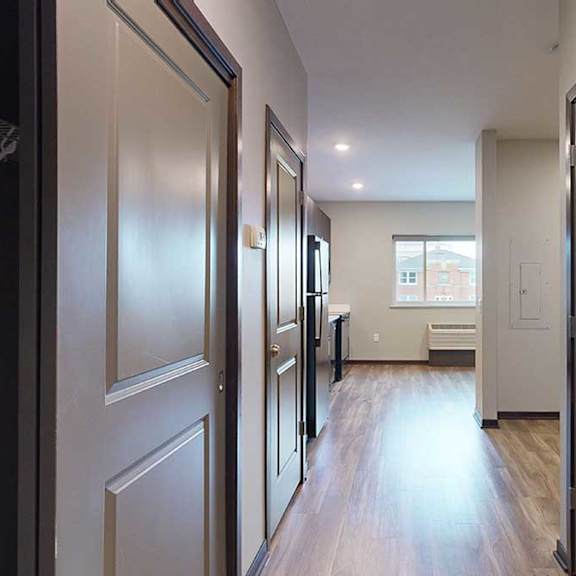 Thumbnail 2 of 17 an entryway with closet doors on both sides