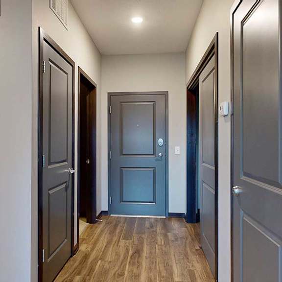 Thumbnail 13 of 17 an entry hallway with access to the bathroom, laundry, and closets