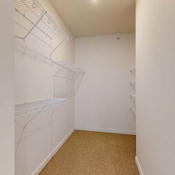 Thumbnail 10 of 28 a large walk in closet with built-in shelving and hanging space