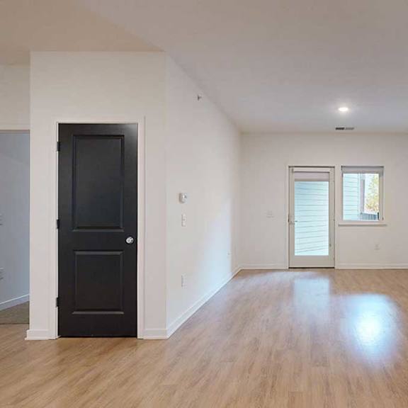 Thumbnail 11 of 28 a living room with access to the patio and parallel bedrooms on opposite sides
