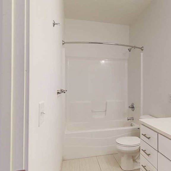 Thumbnail 5 of 28 a bathroom with a granite vanity sink and a combination shower and tub