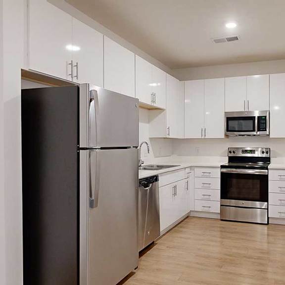 Thumbnail 16 of 28 a modern kitchen with light cabinests, granite countertops, and stainless steel appliances