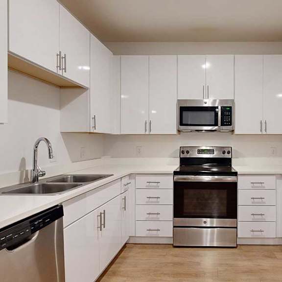 Thumbnail 17 of 28 a modern kitchen with white cabinets and stainless steel appliances