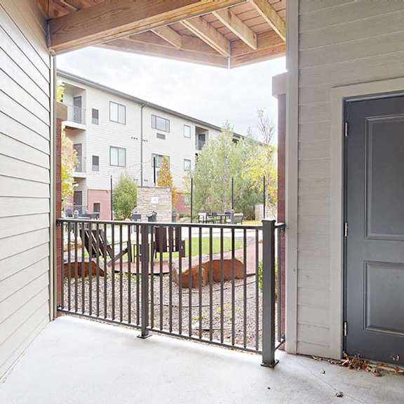 Thumbnail 12 of 28 an elevated patio overlooking the courtyard with a door to the outdoor storage space