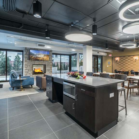 the conrad clubhouse with kitchen and fireside seating-blackstone district omaha ne