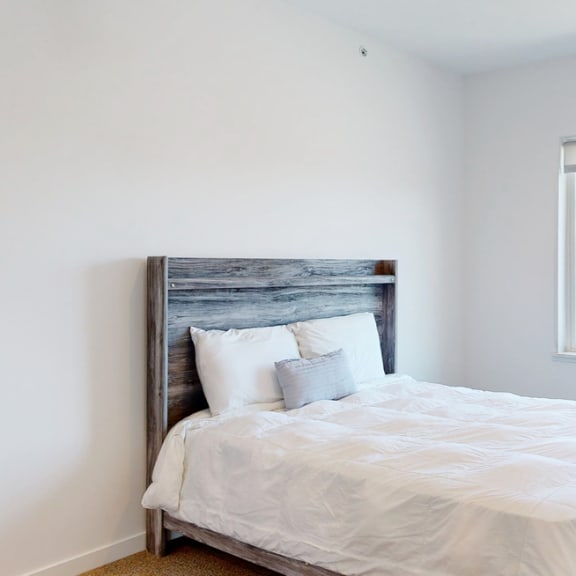 Thumbnail 9 of 15 Furnished apartment bedroom with large single window