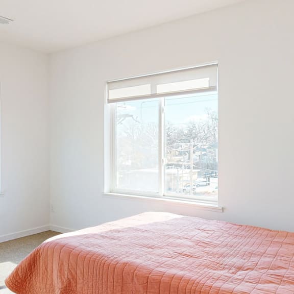 Thumbnail 12 of 15 Furnished apartment bedroom with a large window on each wall