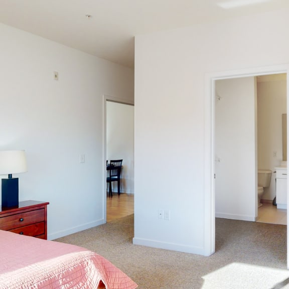 Thumbnail 13 of 15 a bedroom with a bed and a mirror