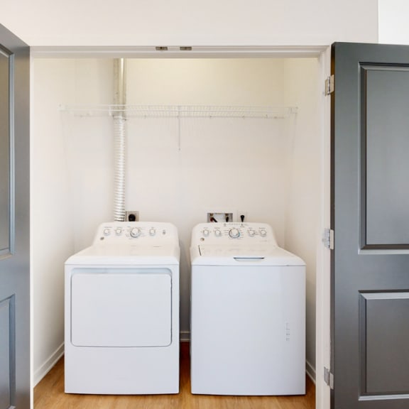 Thumbnail 3 of 15 a small laundry room with two washers and a dryer