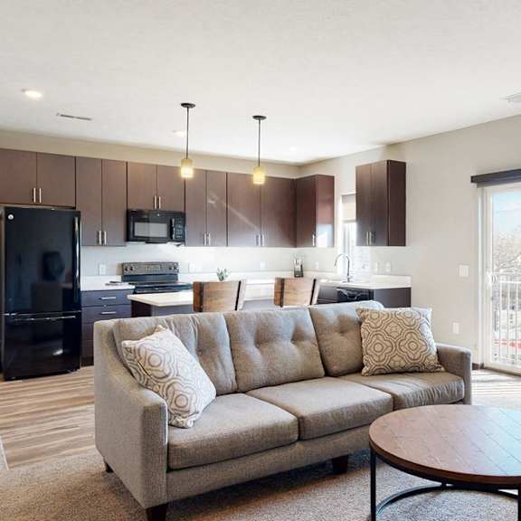 Thumbnail 3 of 9 Furnished apartment living area with sofa and coffee table