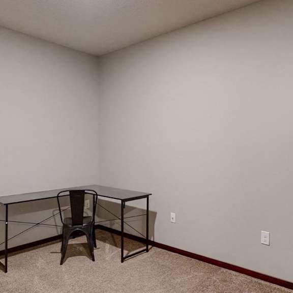 Thumbnail 8 of 9 Furnished apartment den with work desk and chair in corner of room