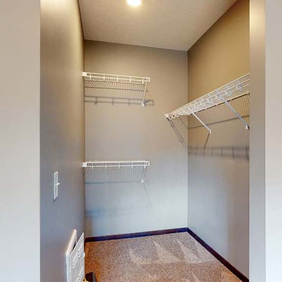Thumbnail 7 of 9 Walk in closet with plenty of shelving and hanging space in a furnished apartment at the conrad