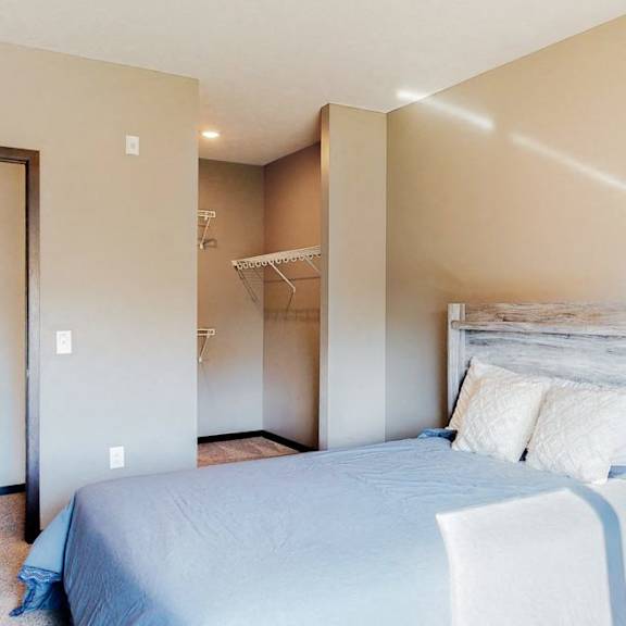 Thumbnail 6 of 9 Furnished apartment bedroom with large walk in closet and easy bathroom access