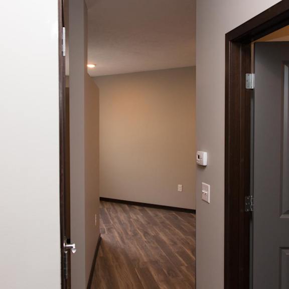 Thumbnail 2 of 7 Entryway of studio apartment with bathroom door to the right