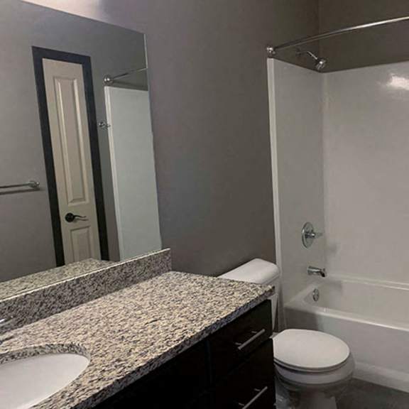 Thumbnail 10 of 21 Spacious bathroom with tub shower and granite countertops in 1 bedroom apartment for rent at The Flats at 84 best apartments Lincoln NE 68516