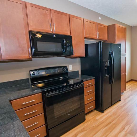 Thumbnail 5 of 14 A kitchen with black appliances