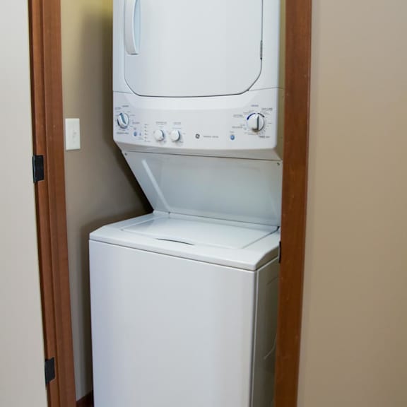 Thumbnail 7 of 13 Stacked washer and dryer in a closet