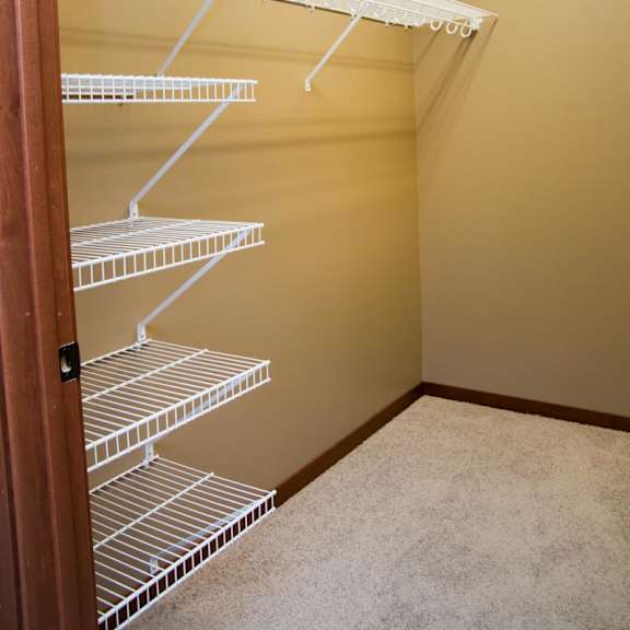 Thumbnail 10 of 13 Empty white wire shelves in large walk-in closet
