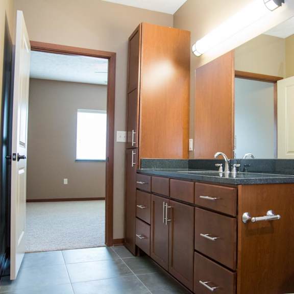 Thumbnail 11 of 13 Bathroom with large vanity with linen storage connected to vanity