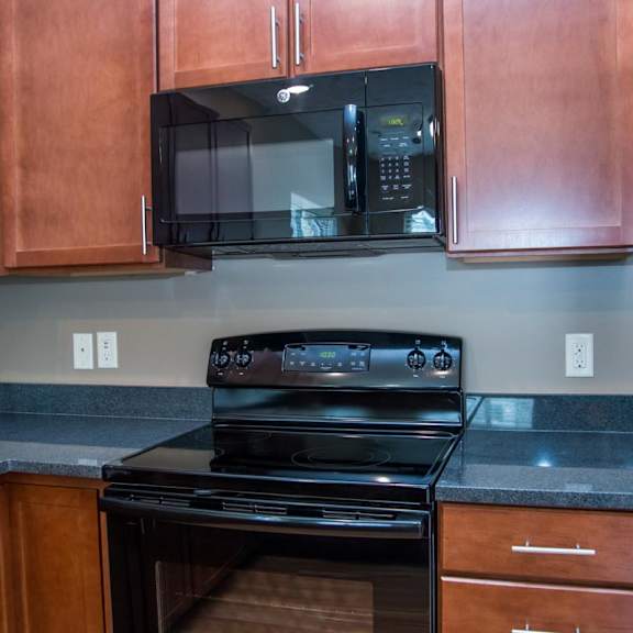 Thumbnail 5 of 13 Black oven with a black microwave above it