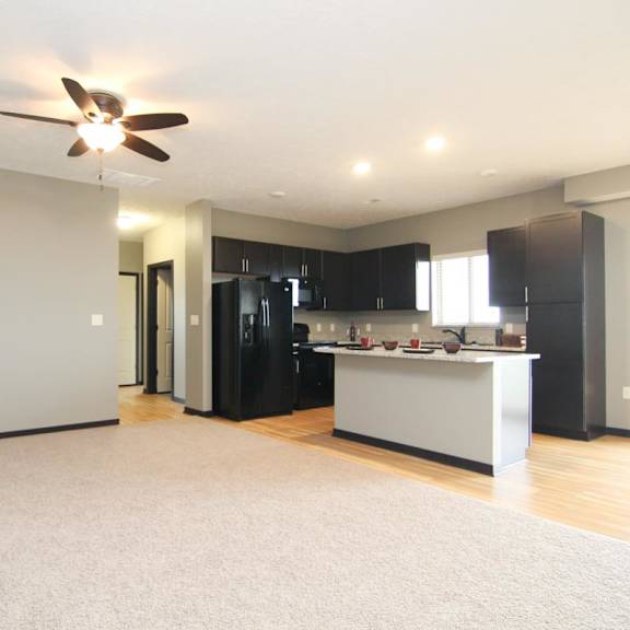 Thumbnail 3 of 14 A spacious living room with a fireplace and a television.
