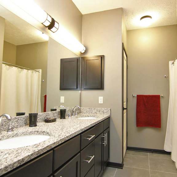 Thumbnail 9 of 14 A bathroom with a sink, mirror, and cabinets.
