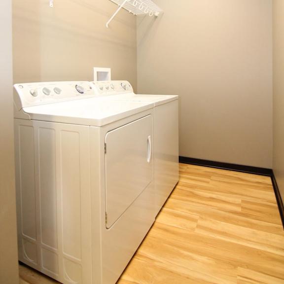 Thumbnail 13 of 14 A white washing machine and dryer in a laundry room.