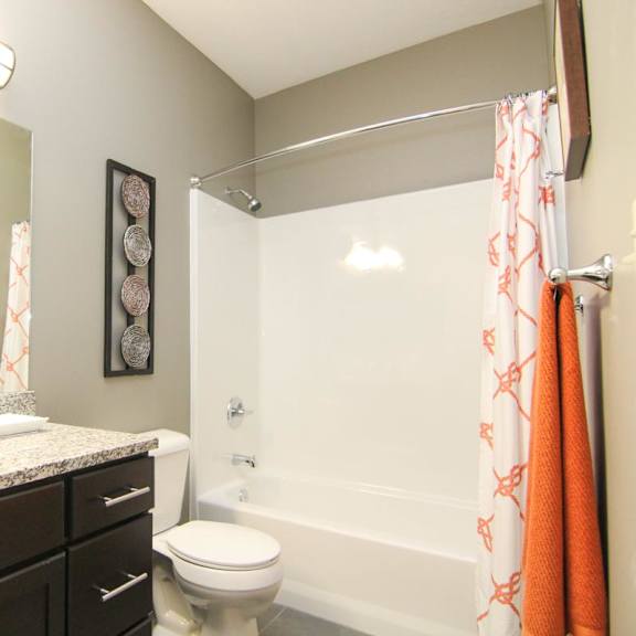 Thumbnail 24 of 24 A bathroom with a toilet, sink, and shower.