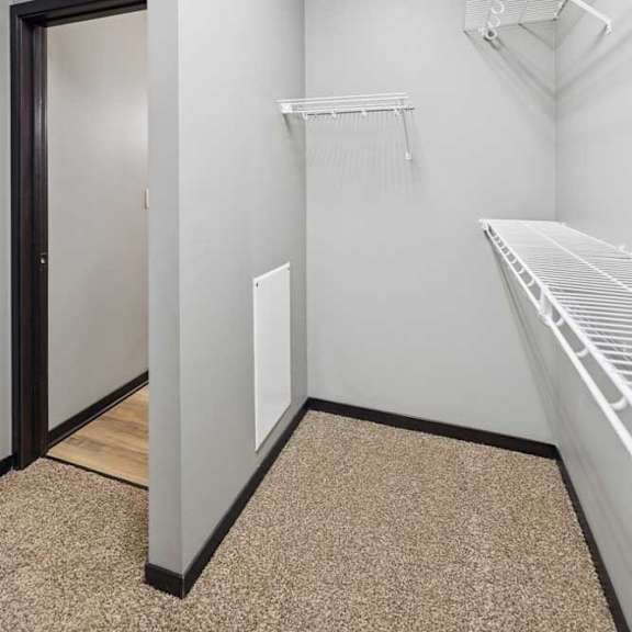 Thumbnail 19 of 33 An oversized walk-in closet with several built-in wire shelves.