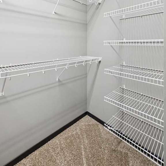 Thumbnail 20 of 33 An oversized walk-in closet with wire shelves.