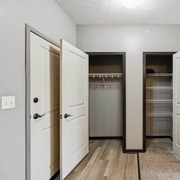 Thumbnail 6 of 33 A hallway closet next to a pantry with several shelves.