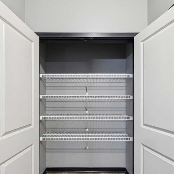 Thumbnail 33 of 33 A double door linen closet with several built-in shelves.