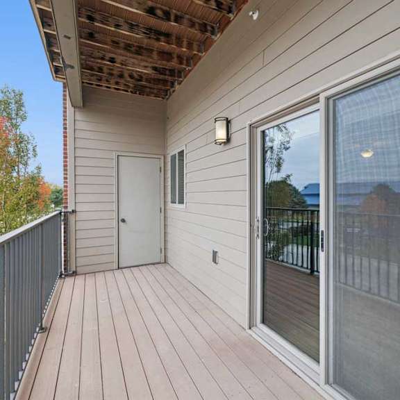 Thumbnail 15 of 33 An oversized balcony with a sliding glass door and outdoor storage closet.