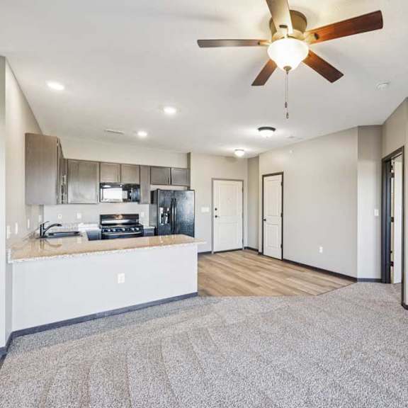 Thumbnail 20 of 30 A spacious kitchen with a ceiling fan and a fireplace.