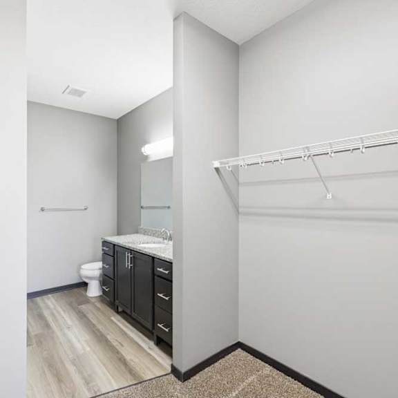 Thumbnail 25 of 30 A white bathroom with a toilet, sink, and a shelf.