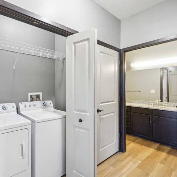 Thumbnail 21 of 30 A white washer and dryer in a small laundry room.