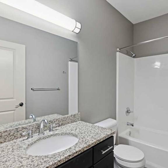 Thumbnail 14 of 23 A bathroom with a sink, toilet, and bathtub.