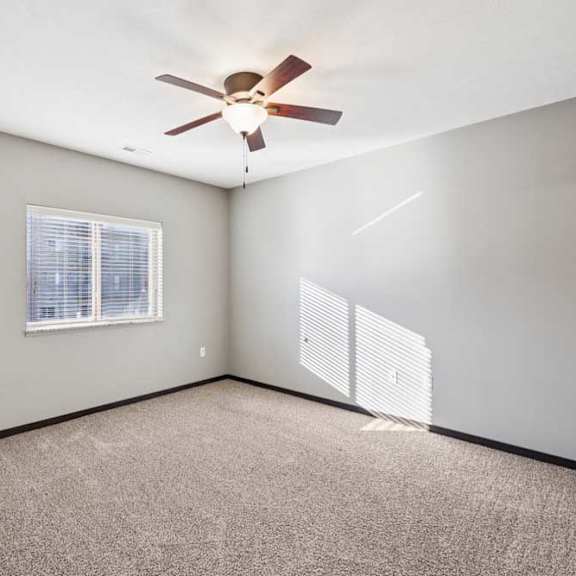 Thumbnail 15 of 23 A room with a ceiling fan and a window.