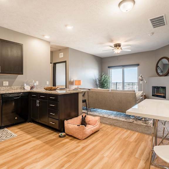 Thumbnail 3 of 12 an open kitchen and living room with a fireplace and a table