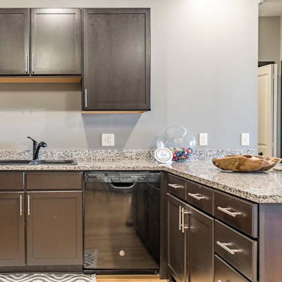 Thumbnail 5 of 12 Style A design with dark cabinetry and light granite countertops