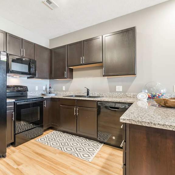 Thumbnail 4 of 12 a large kitchen with stainless steel appliances and granite counter tops