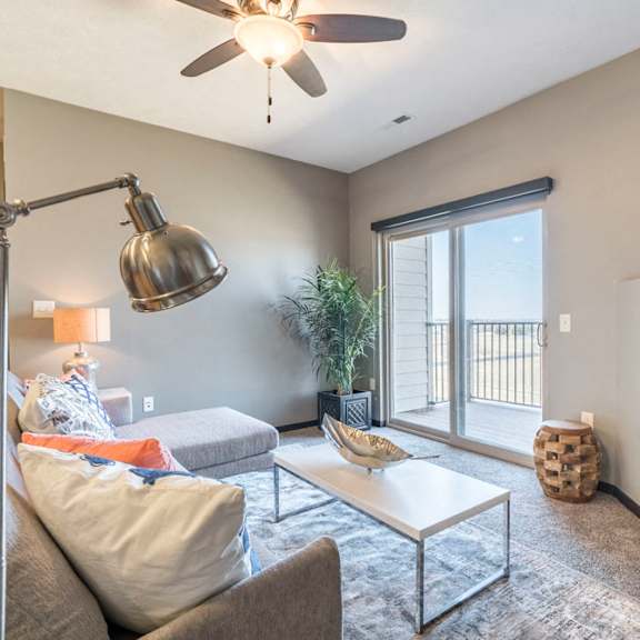 Thumbnail 6 of 12 Open layout living room with fireplace at The Flats at 84 in southeast Lincoln NE 68516