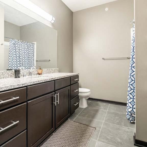 Thumbnail 9 of 12 Bathroom with granite countertops and tile flooring at The Flats at 84 in southeast Lincoln NE 68516