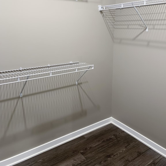 Thumbnail 12 of 16 Walk-in closet with shelving and rods in the Plum studio apartment