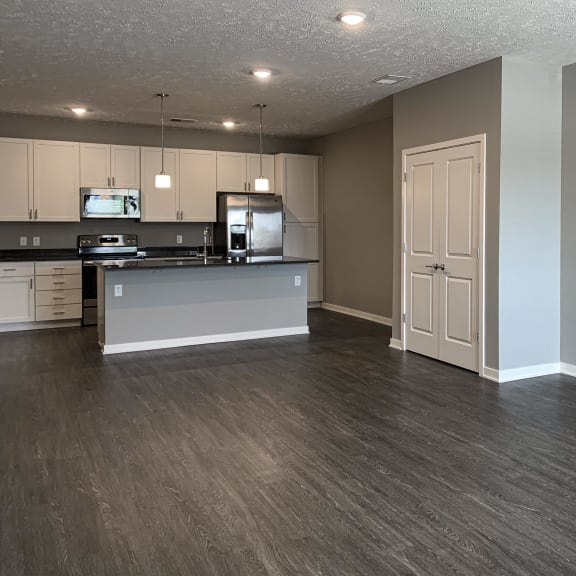 Thumbnail 18 of 20 Living and dining area leading into the kitchen in the buffalo floorplan at the flats at shadow creek