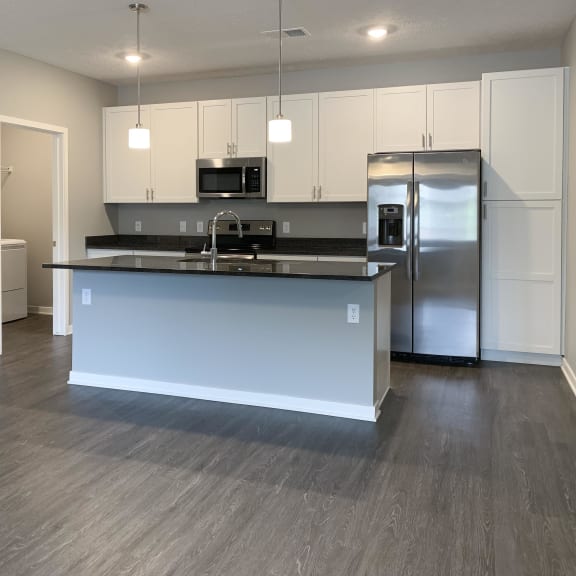 Thumbnail 7 of 23 Kitchen with white cabinets and dark granite counters The Flats at Shadow Creek in Lincoln Nebraska