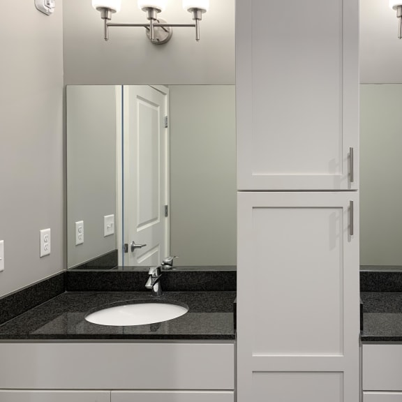 Thumbnail 13 of 23 Bathroom with dual sinks and white cabinetry The Flats at Shadow Creek in Lincoln Nebraska