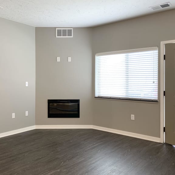 Thumbnail 14 of 23 Living room area with electric fireplace on the center wall