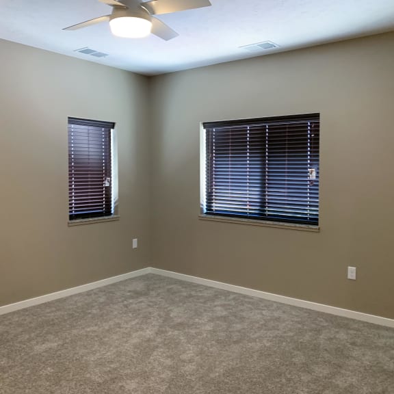 Thumbnail 9 of 15 Carpeted bedroom with two windows on either wall