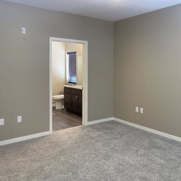 Thumbnail 11 of 15 carpeted bedroom with private master bathroom